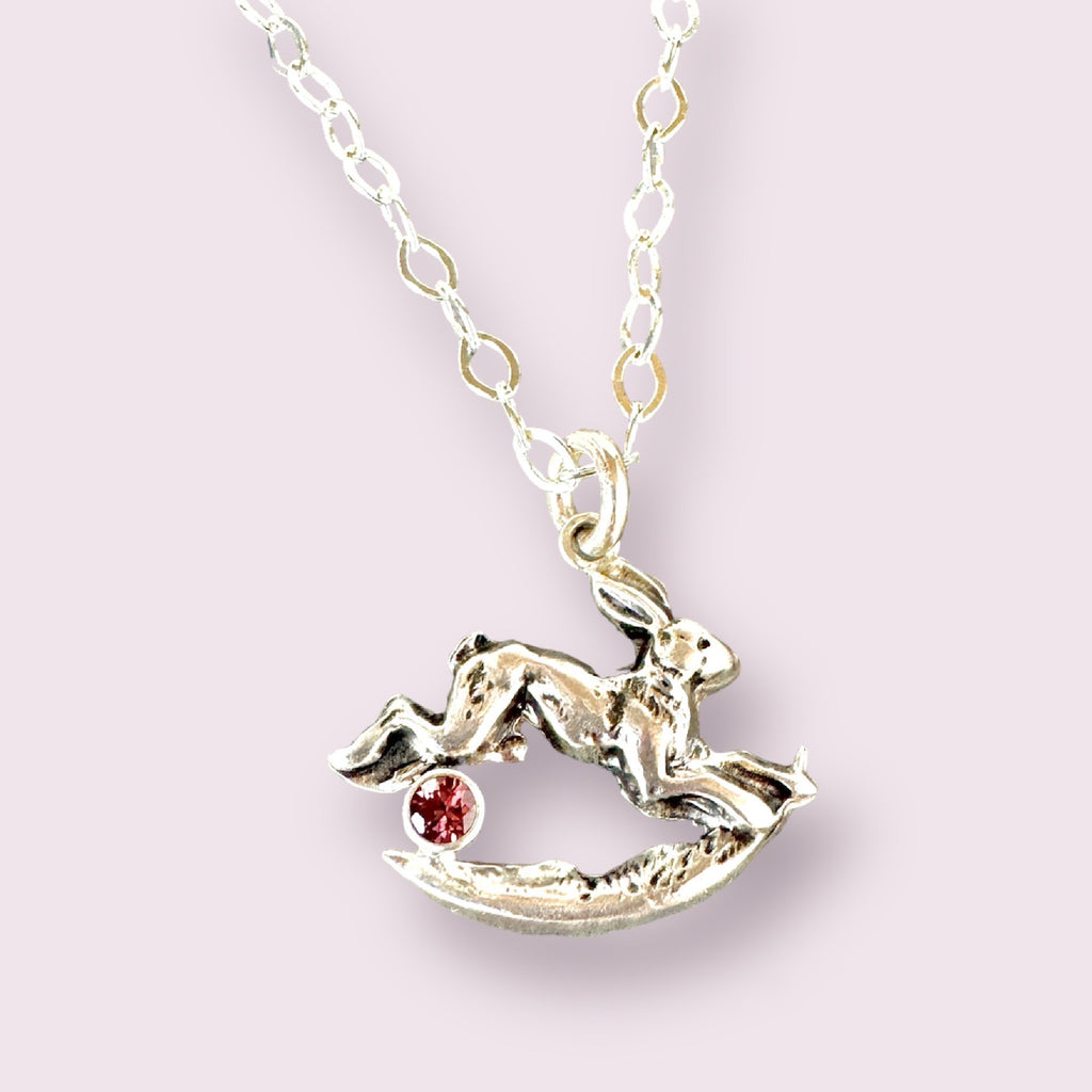 Rabbit jumping over the moon pendant in sterling silver. #mm rose colored zircon gemstone.