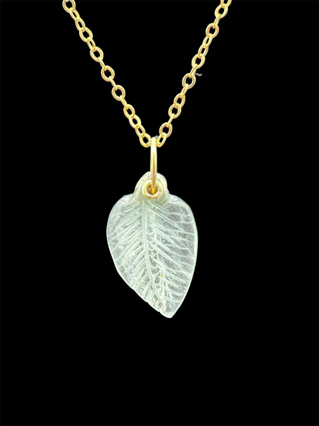 Hand carved aquamarine in the shape of a leaf. Riveted with an 18K yellow gold bail.