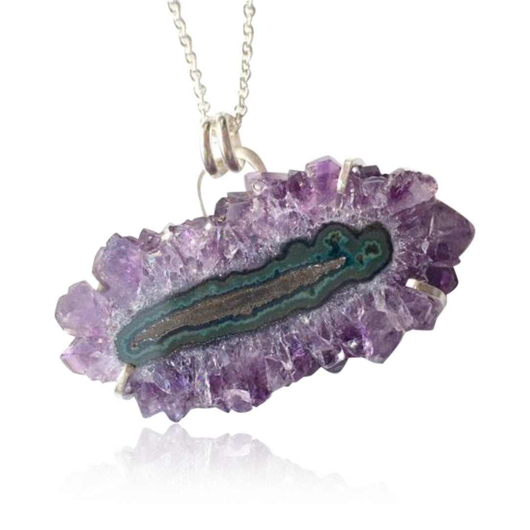 The natural crystal structure is a deep purple with a greenish middle circle. 

The stone itself is about 2&quot; x 1&quot; and comes on a sterling silver chain that can be worn at 16&quot; or 18&quot;. Handmade hook and eye clasp.