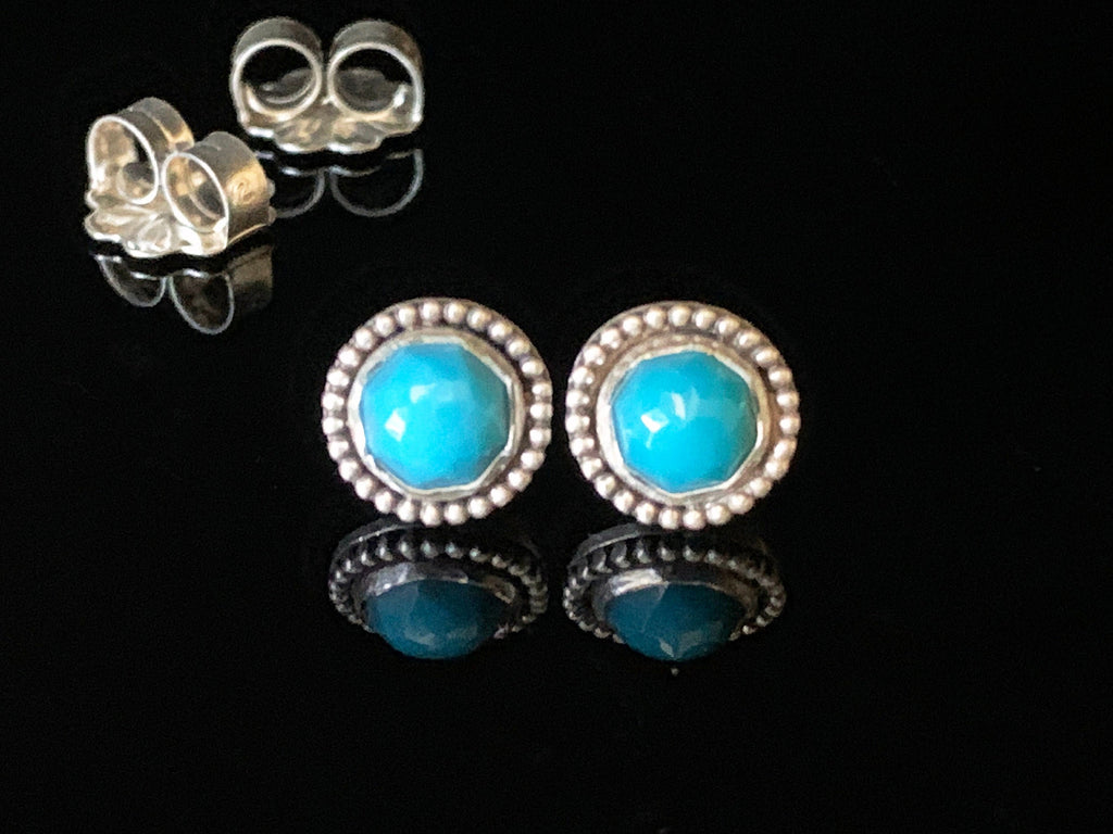Turquoise stud earrings. AAA quality Turquoise that have a faceted rose cut. They are in a sterling silver setting that has a beaded detail around the edge
They are 3/8&quot; (9mm) in size and are solid sterling silver.