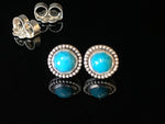 Load image into Gallery viewer, Turquoise stud earrings. AAA quality Turquoise that have a faceted rose cut. They are in a sterling silver setting that has a beaded detail around the edge
They are 3/8" (9mm) in size and are solid sterling silver.
