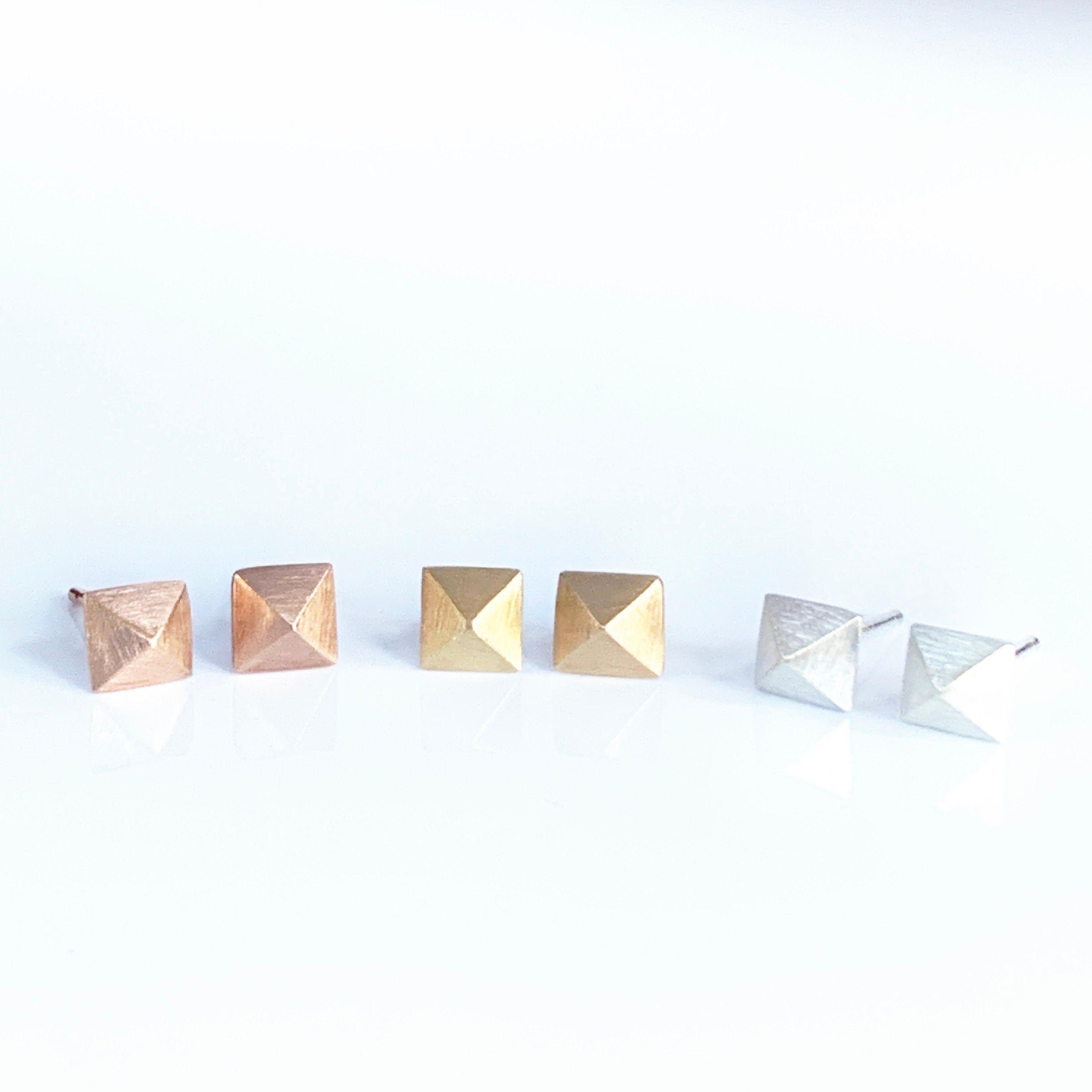 These four sided pyramids are created using a shot plate to form the gold or silver into a pyramid. They are great for everyday wear.

The earrings are about 1/4&quot; in size (5mm) and have a brushed finish.