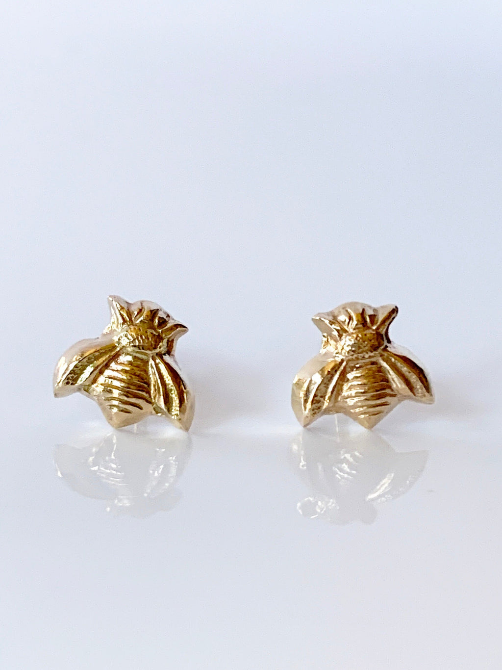 Solid 14K gold stud earrings in the shape of a bee. Created using a vintage jewelry die.