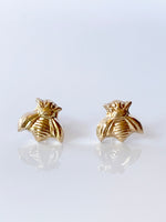 Load image into Gallery viewer, Solid 14K gold stud earrings in the shape of a bee. Created using a vintage jewelry die.
