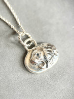 Load image into Gallery viewer, Roaring lion pendant in sterling silver with blue sapphire eye.
