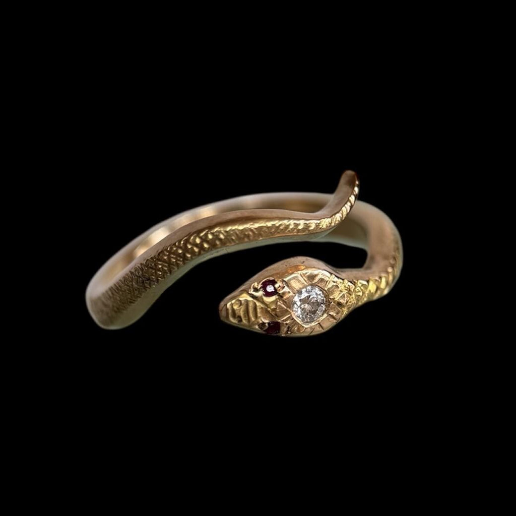 Solid 14K yellow gold snake ring with center white diamond and ruby gemstone eyes.
