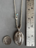 Load image into Gallery viewer, Egyptian Revival Scarab Beetle pendant in sterling silver, vintage die , art deco, hieroglyphics
