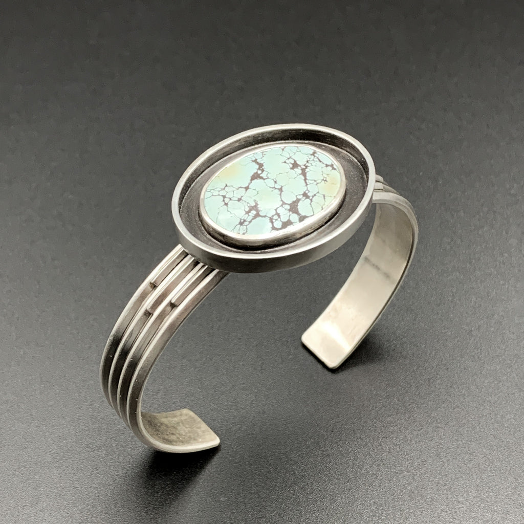 Turquoise cuff bracelet in sterling silver. Art Deco styling.
